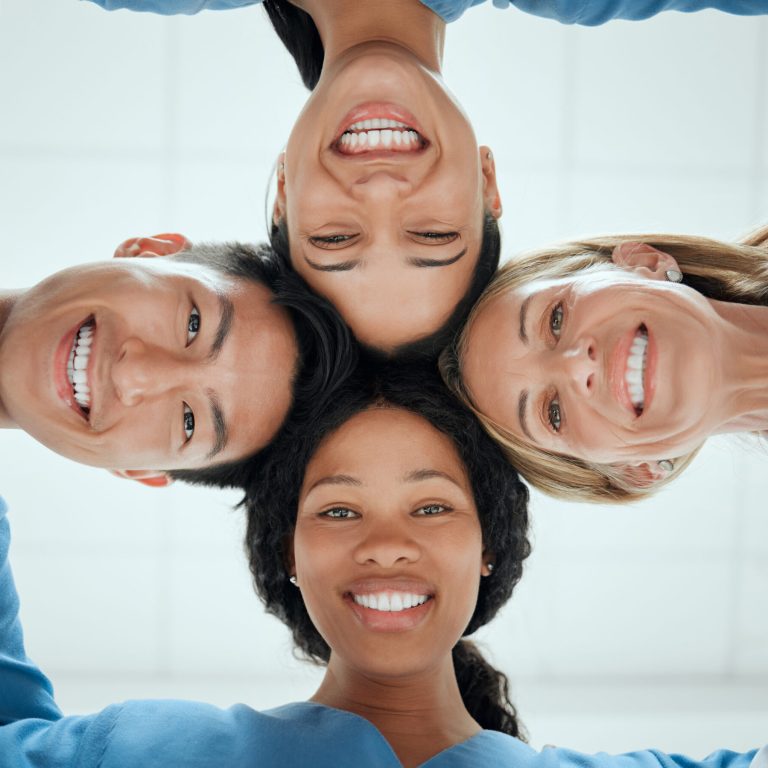 Cropped shot of a group of medical practitioners having a private huddle at work.